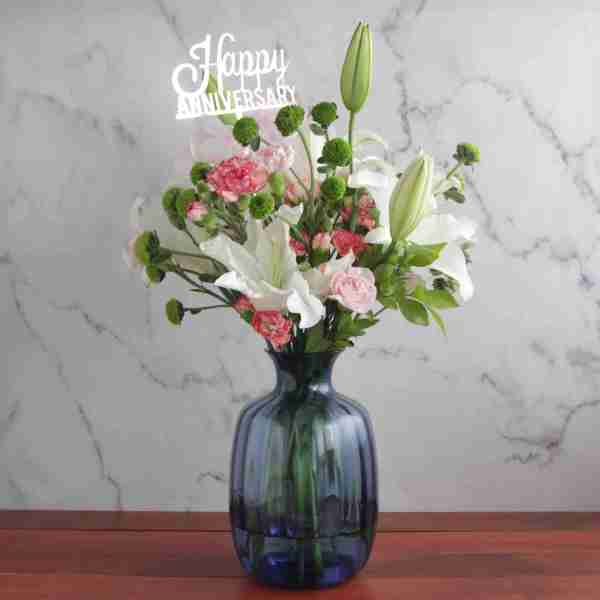Blue Vase Arrangement With Happy Anniversary Topper