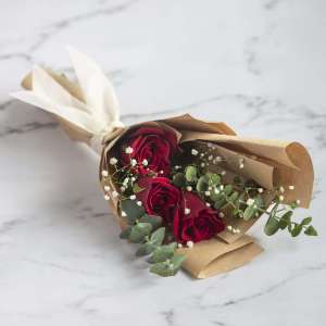 Hand Bouquet Of Red Roses And Eucalyptus