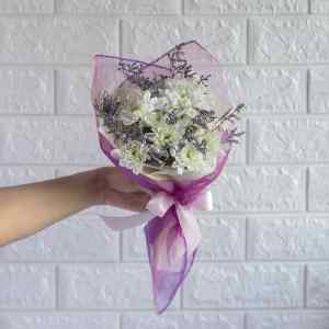 Hand bouquet of white chrysanthemum and limonium