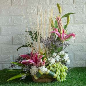 Lilies , dry sticks and white carnations with grapes